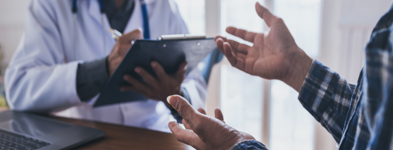 doctor holding ipad talking to another person